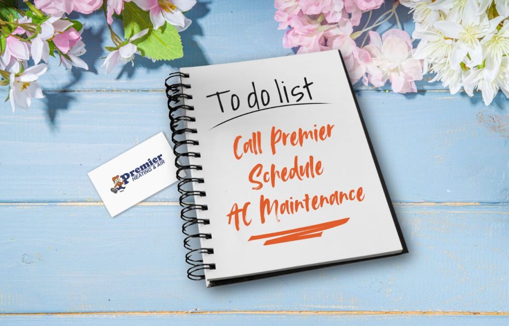 This is an image of a to-do list that says call Premier schedule, AC maintenance and a business card for Premier heating and